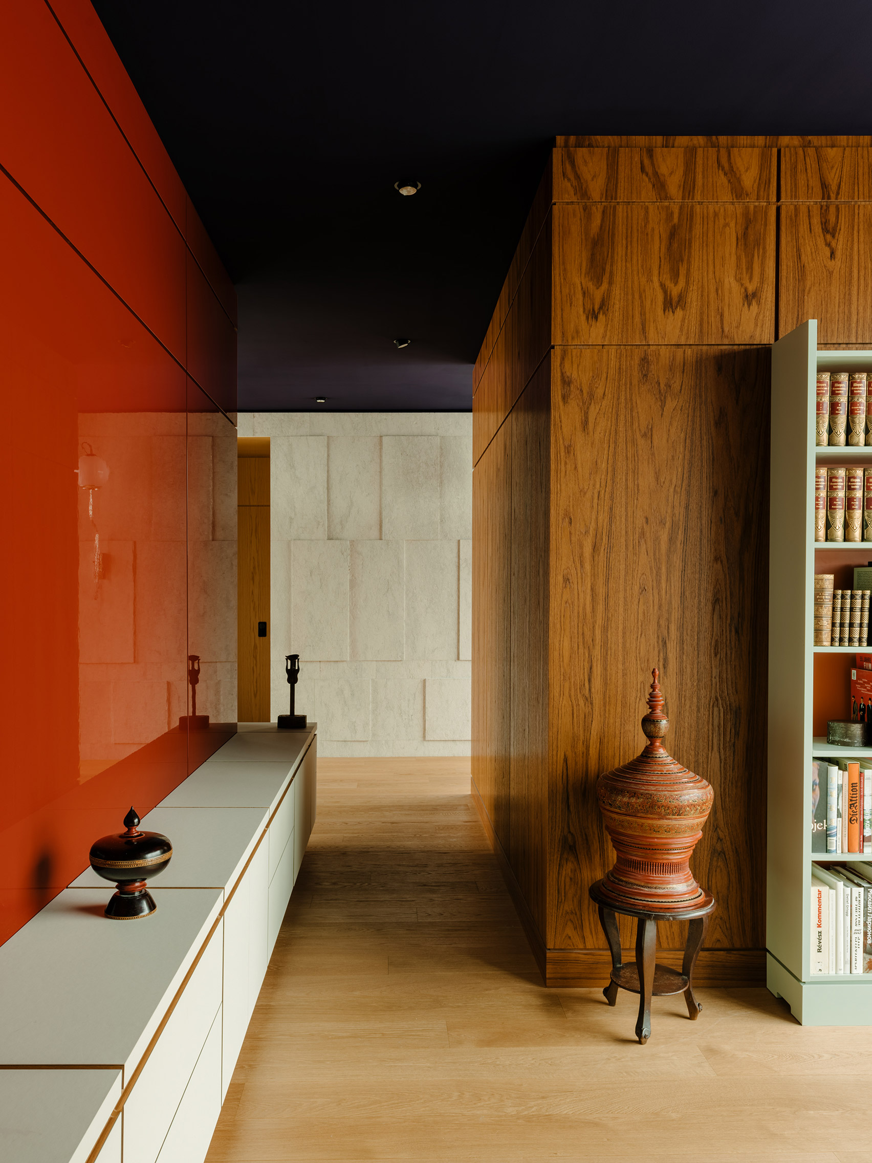 Walls clad in teak, red-lacquered wood and limestone in interior of Berlin apartment The Village designed by Gisbert Pöppler