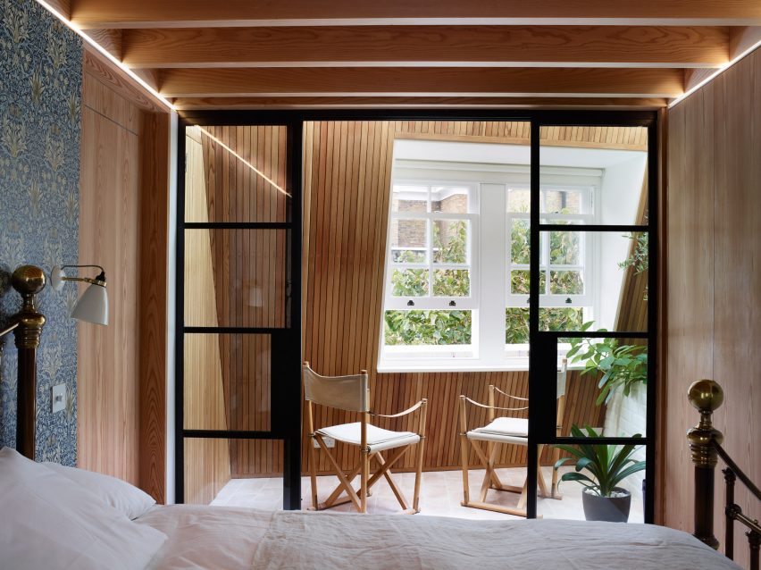 Bedroom with wood-panelled sun terrace in Danish Mews House 