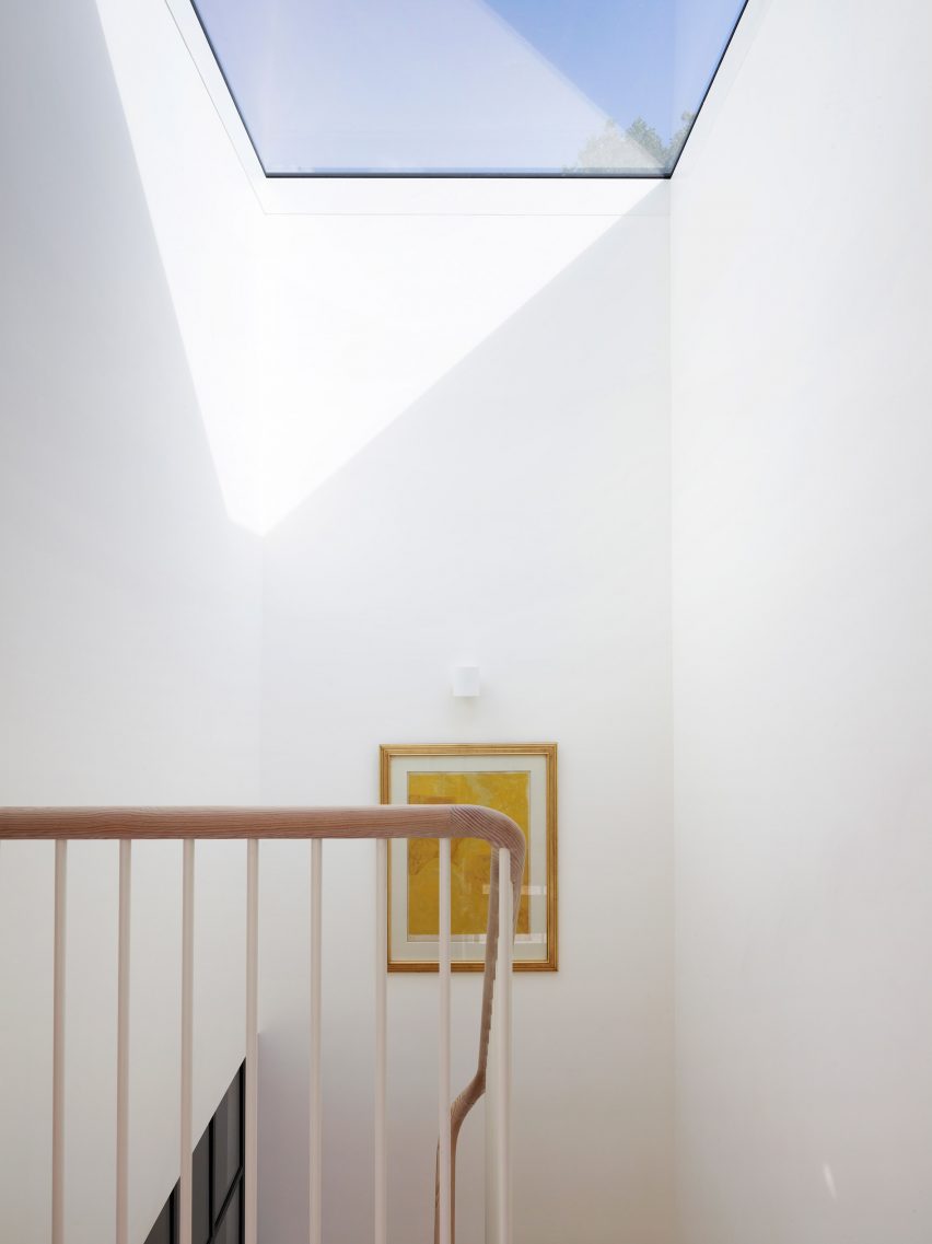 Staircase illuminated by skylight inside Danish Mews House by Neil Dusheiko Architects