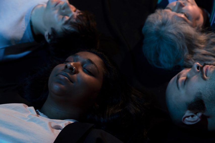Four people lying down inside Dreamachine