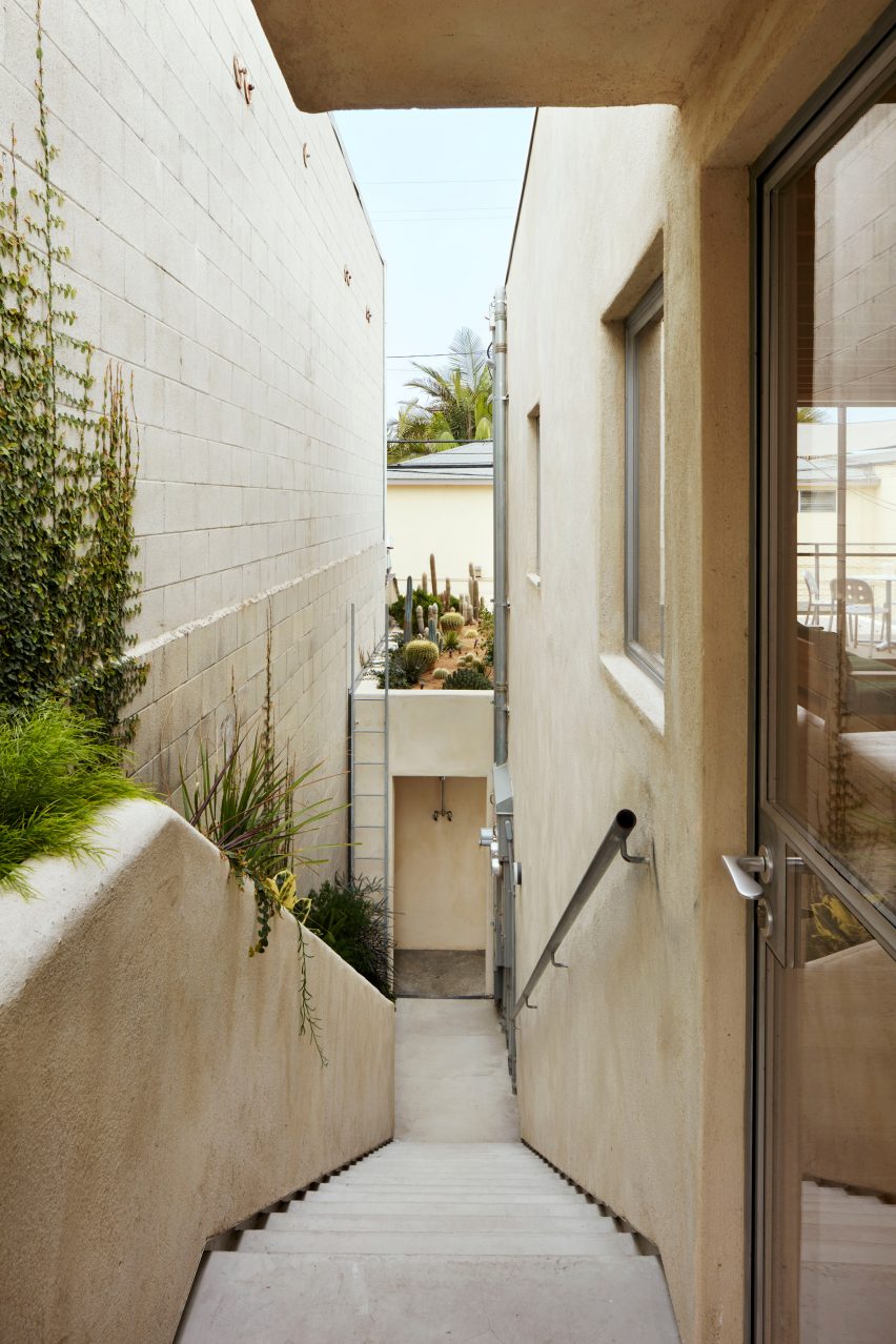 Exterior of Emeco House by David Saik with plaster walls, steel framed door and exterior staircase