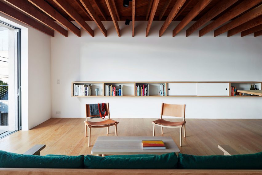 Upstairs sitting area at Emeco House by David Saik with two chairs around a coffee table and sofa 