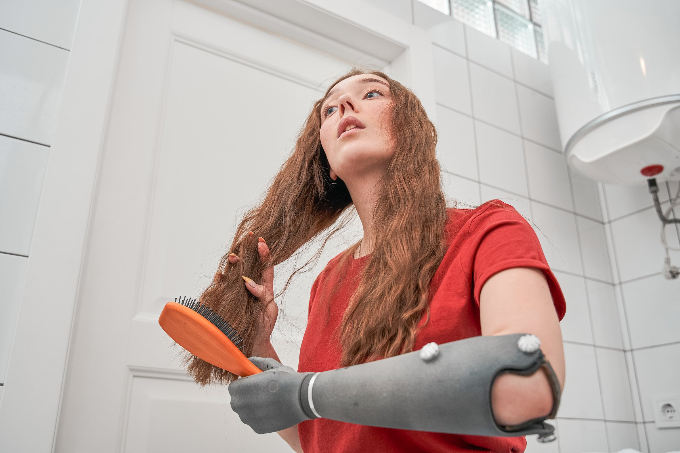 A woman brushing her hair with Esper Hand