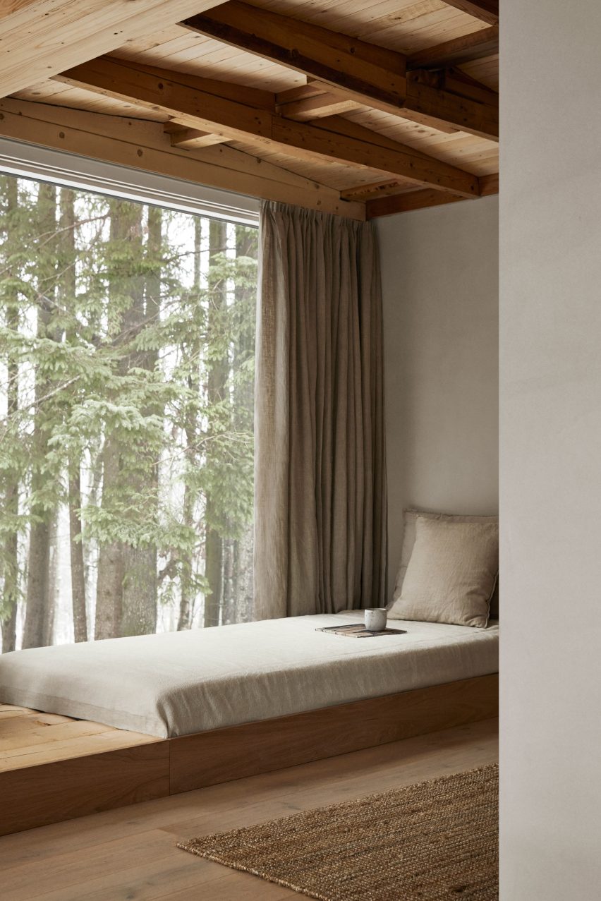 Window seat in minimal interiors of forest retreat in Sweden designed by Norm Architects