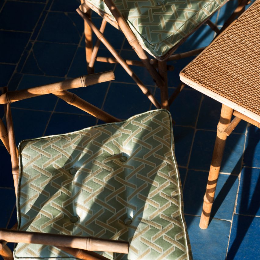 Green Geometric patterns fabric by Dedar used as cushion covers on wooden chairs