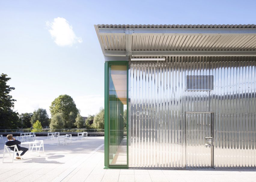 The corrugated steel pavilion has a mirror effect at Crous University Refectory