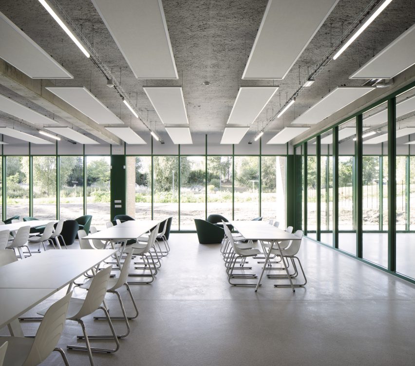 Floor-to-ceiling windows line the walls of the university building