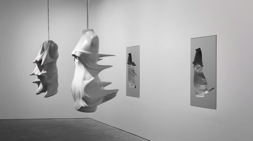 Moulds of busts from the Inertia collection are suspended from the ceiling