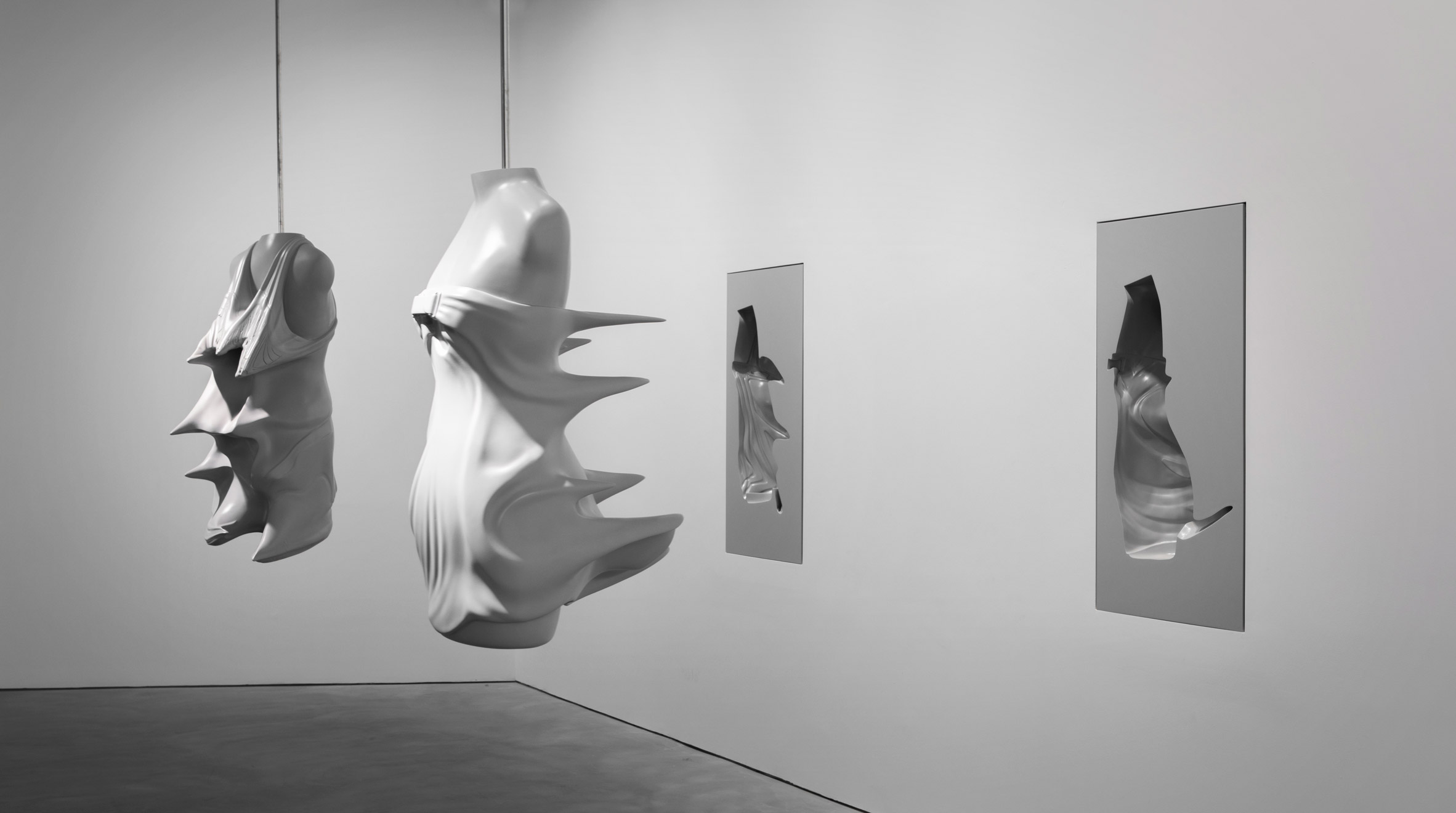 Moulds of busts from the Inertia collection are suspended from the ceiling