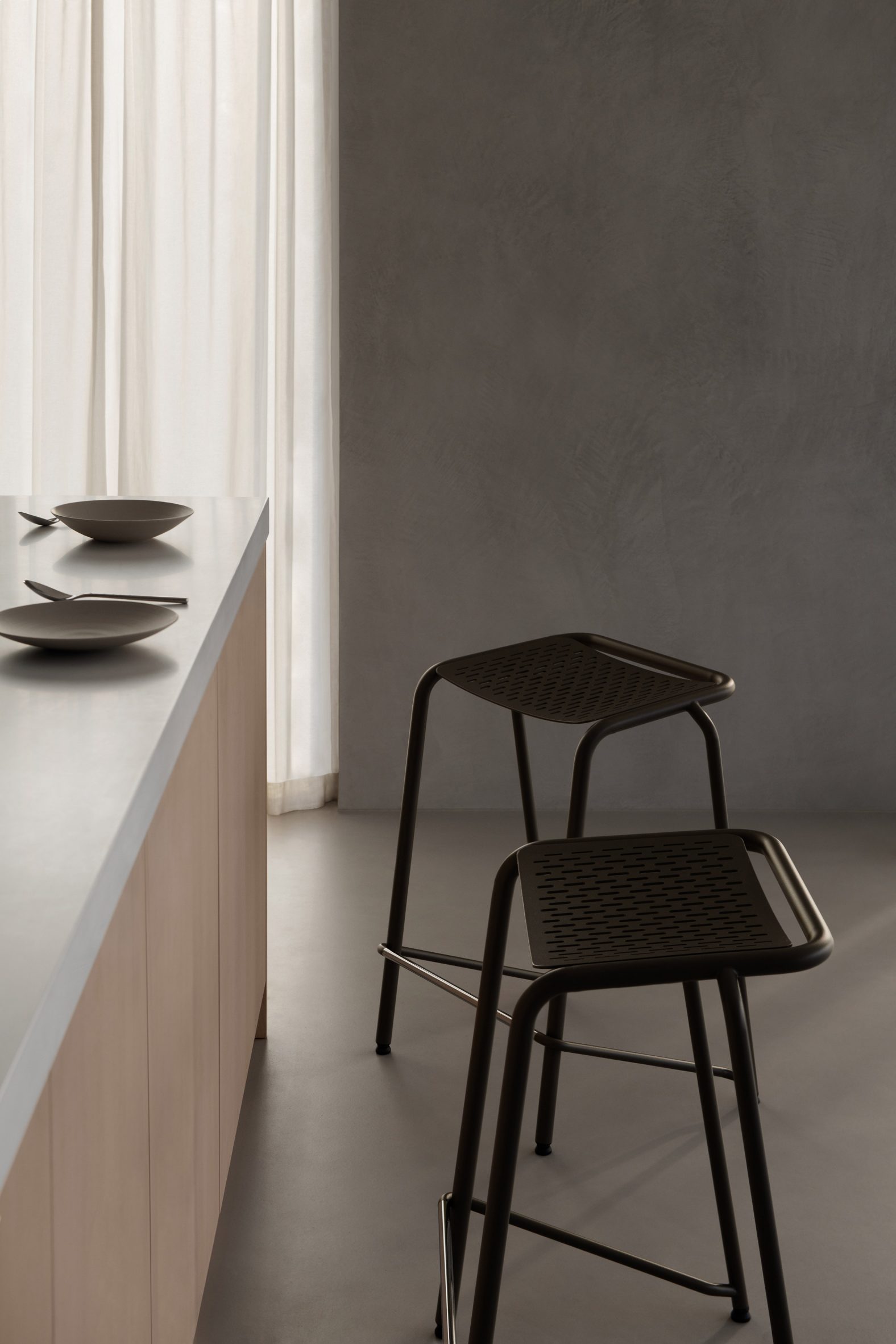 Two black stools and a kitchen counter
