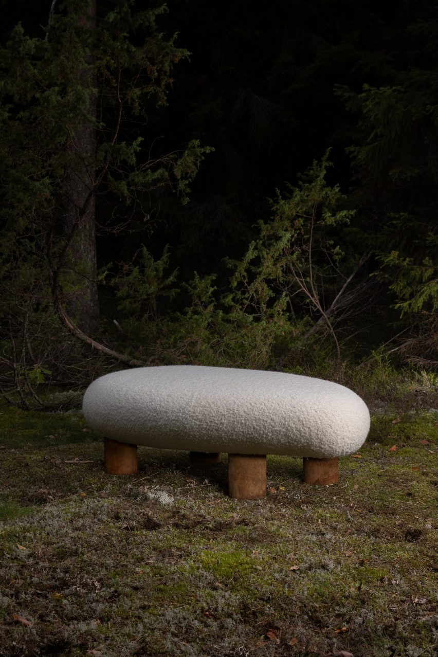 Bench with brown legs and woollen seat from Fomes seating collection in a forest
