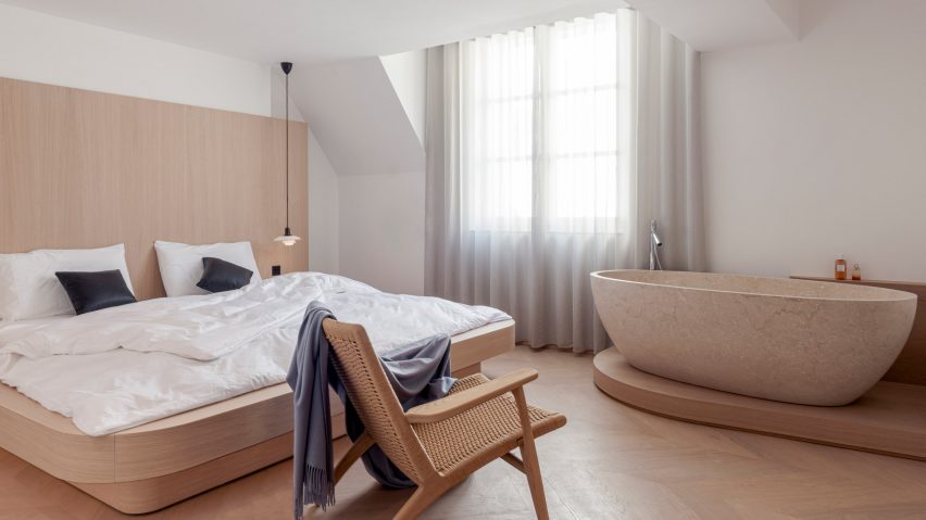Bedroom with marble bath in Le Marais apartment, Nicolai Paris by NOA