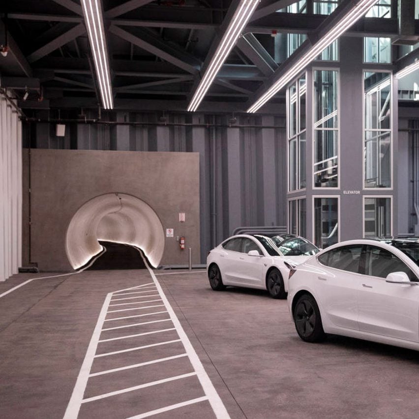Entrance to The Boring Company's LVCC Loop system with white Teslas in front, used to illustrate a story about the North Miami Beach Loop