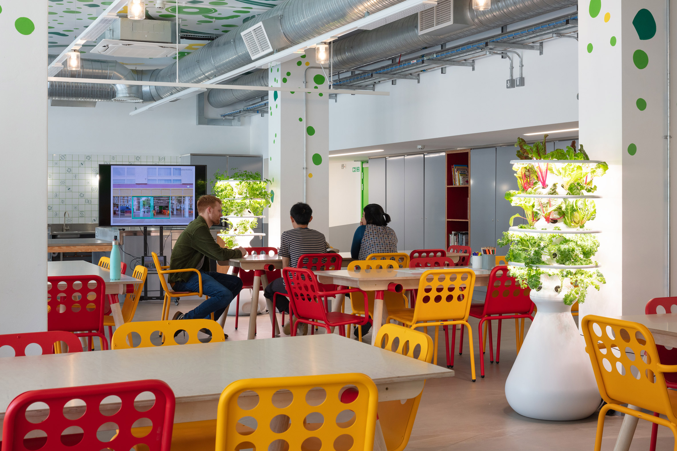 Red and yellow chairs in Nourish Hub by RCKa