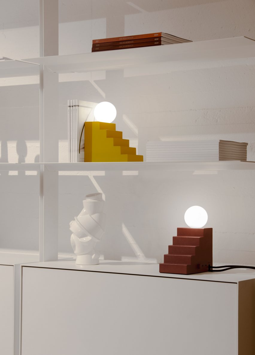 Stair table lamp has a sphere light balanced on a stair-like structure