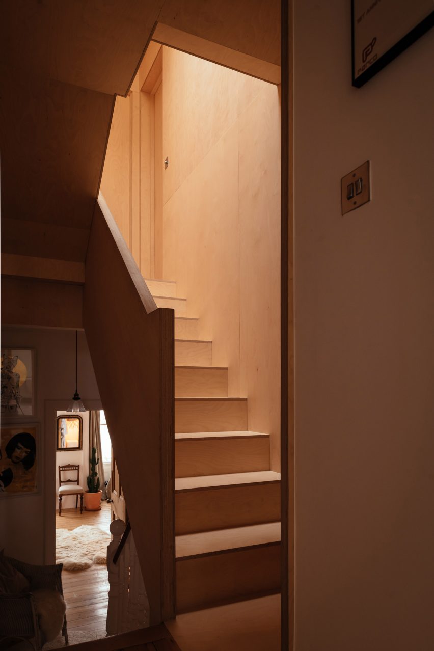 The staircase of Loft 62 is lined in plywood