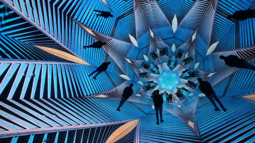 Blue graphics play on LED tiles inside a giant walk-through kaleidoscope