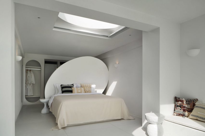 Bed with huge round protruding headboard in hotel interior by GS Design