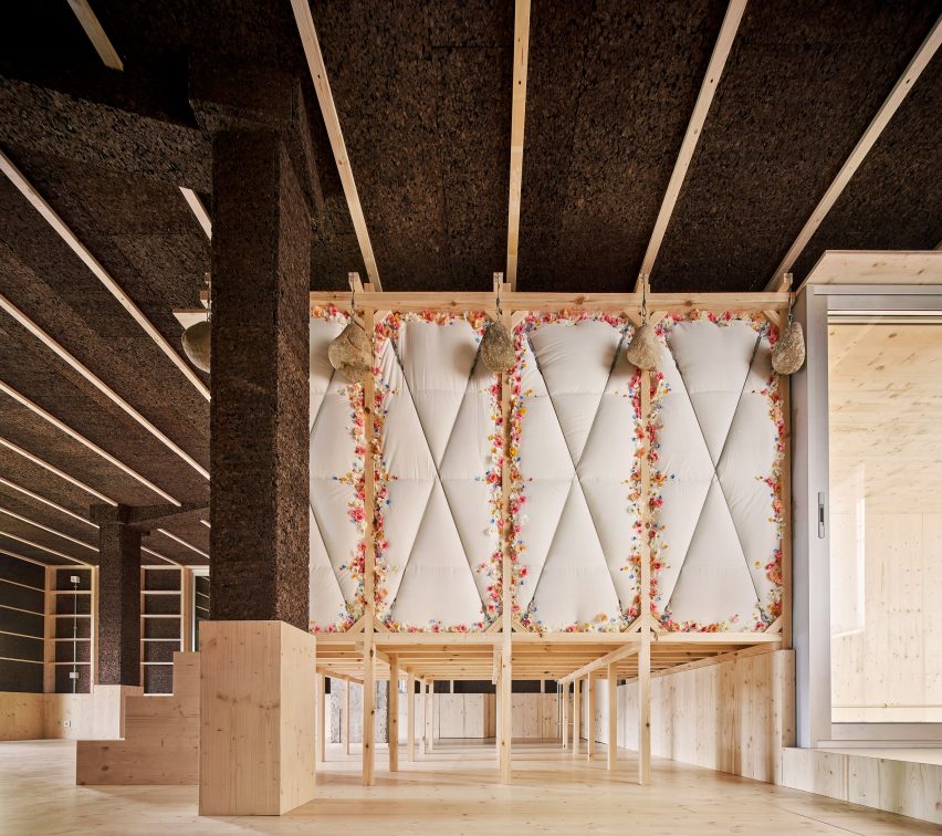 Raised bedroom on stilts with fake flower garlands in Day after House by Takk