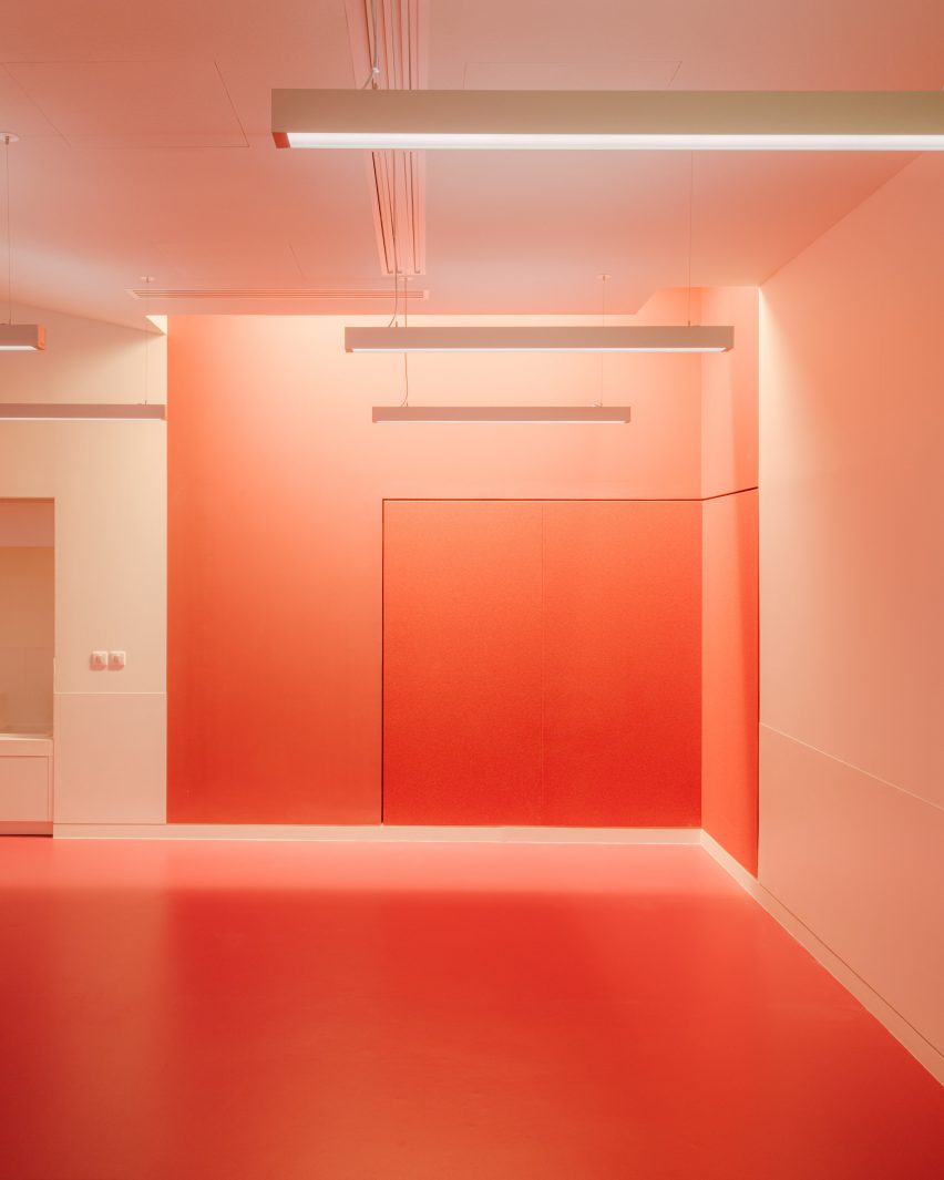 Red-painted workshop inside The Studio at the Louvre museum designed by h2o Architectes