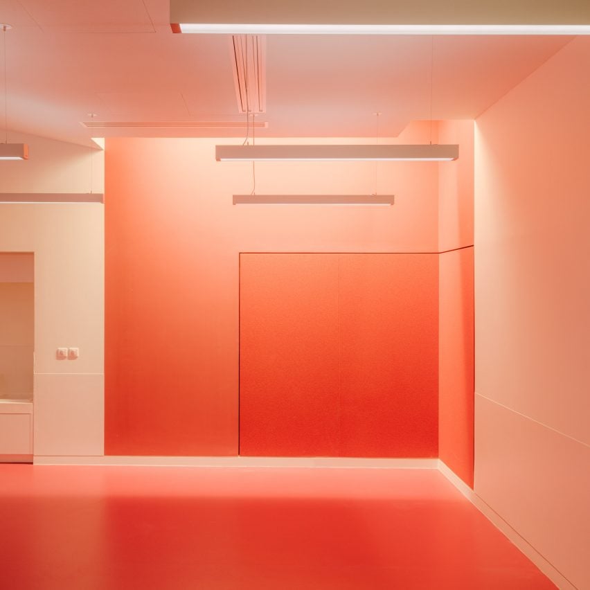 Red-painted workshop inside The Studio at the Louvre museum designed by h2o Architectes