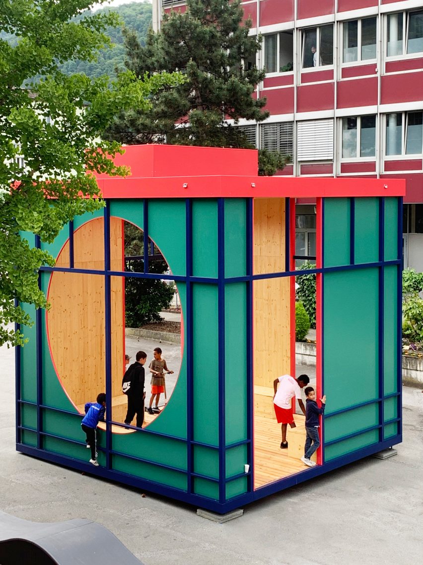 A cubed public structure with people inside