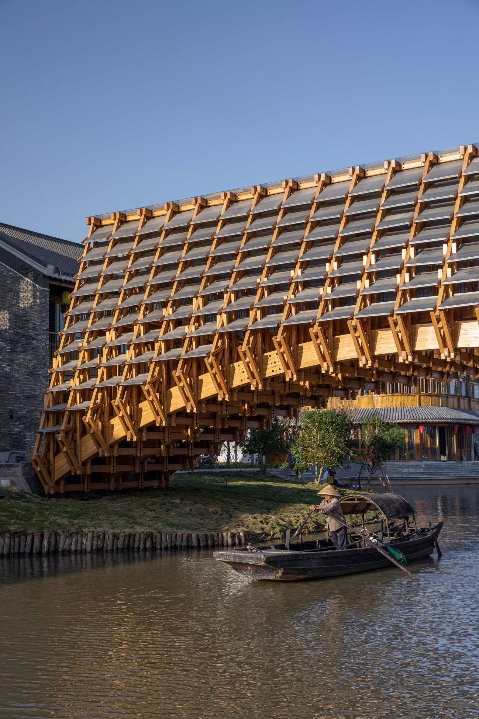 LUO Studio completes intricate wooden bridge in Chinese water village