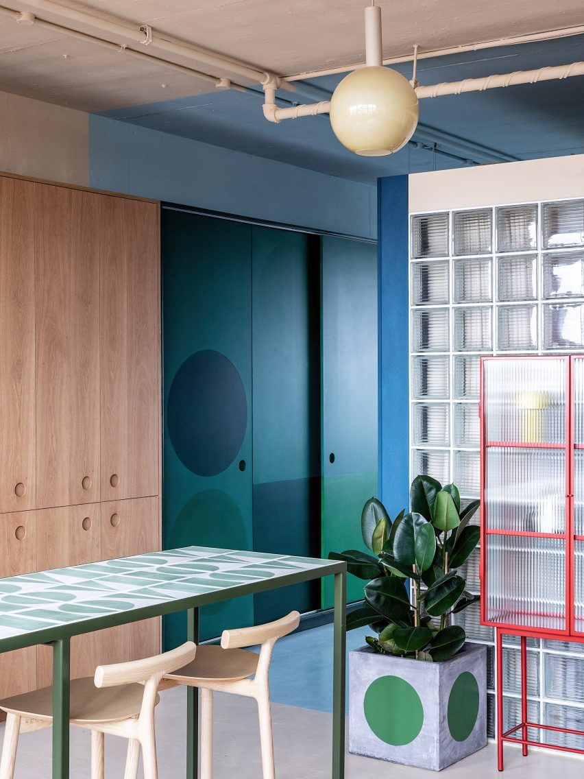Blue walls and wooden kitchen in London office
