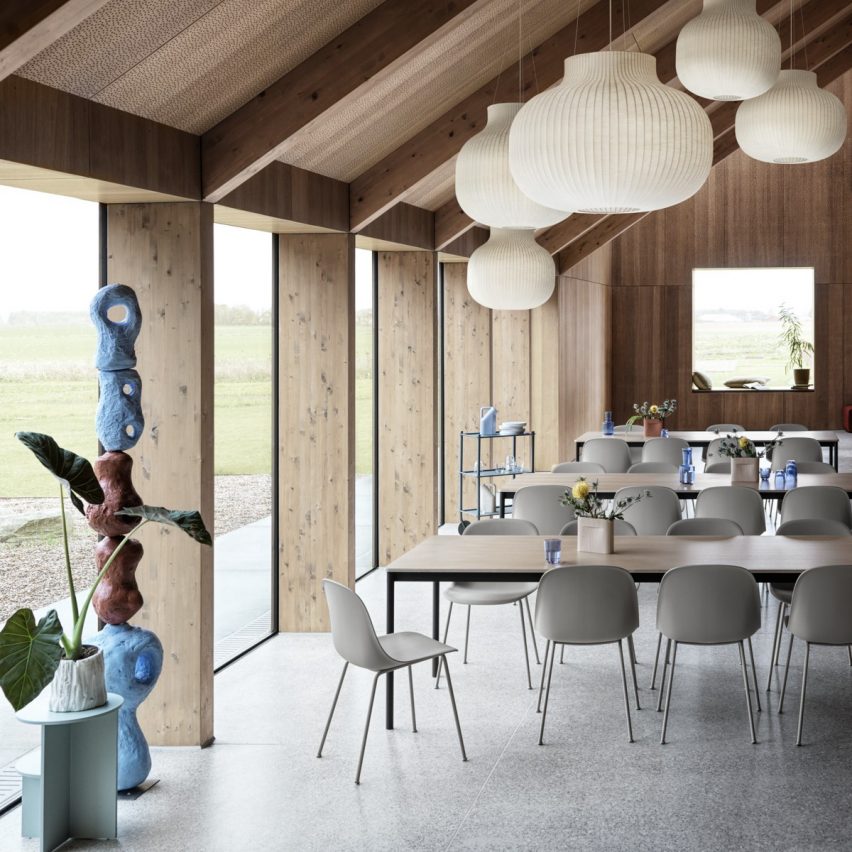 A set of Muuto Fiber side chairs with grey bases surround an oak table