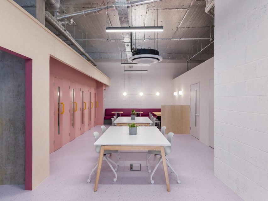 White workbenches next to wall of baby pink doors in ARC Club Camberwell