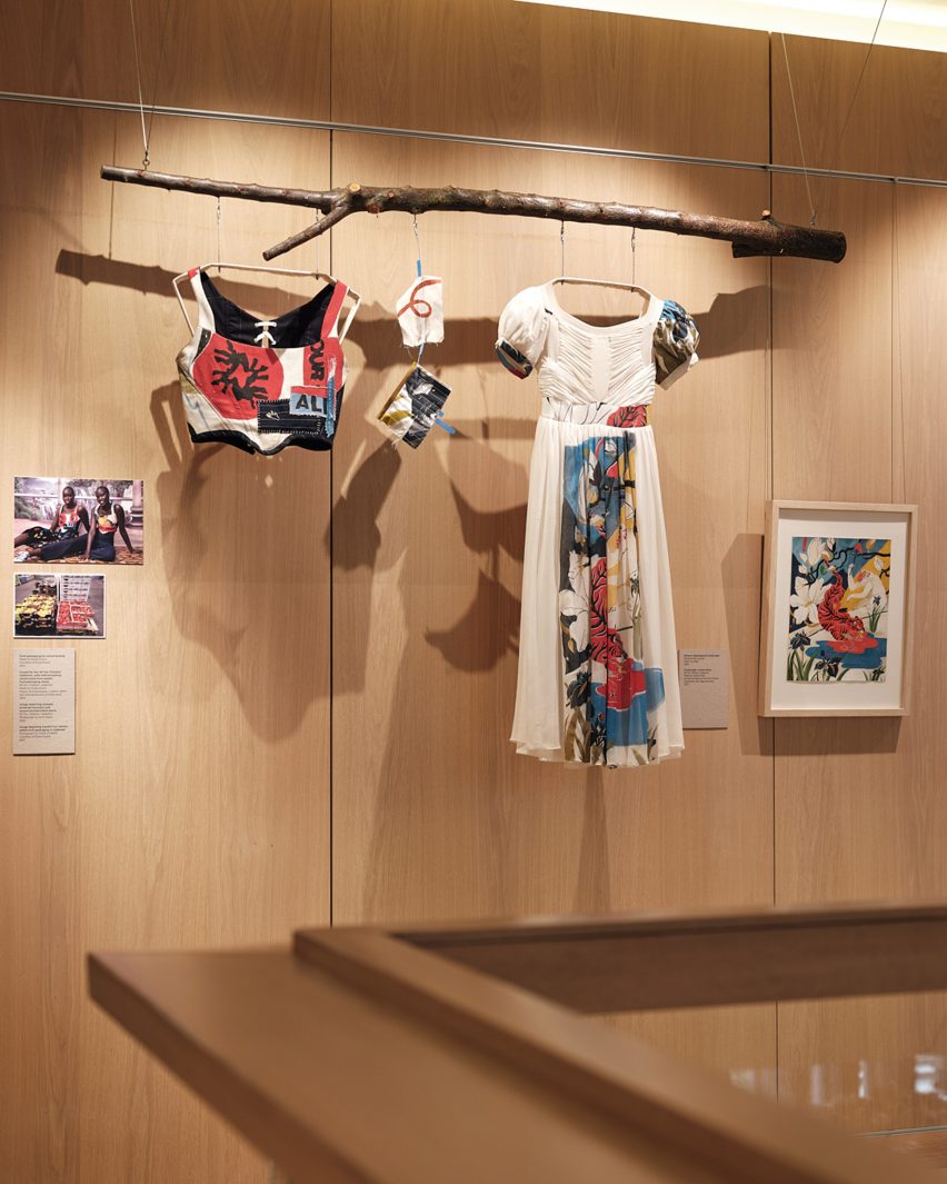 Printed and patchwork clothing pictured suspended on the walls of the Design Museum