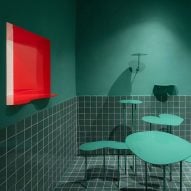 Red window in sea green seating area of Madrid's Cara Mela pastry shop designed by Case Antillón