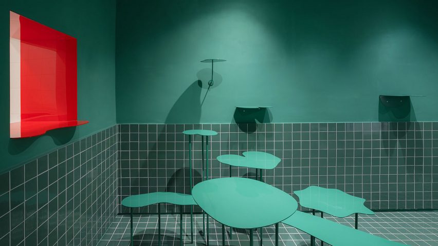Red window in sea green seating area of Madrid's Cara Mela pastry shop designed by Case Antillón