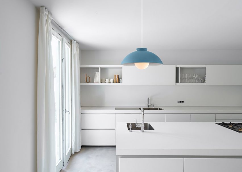 Blue Chelsea chandelier by Innermost in a white kitchen