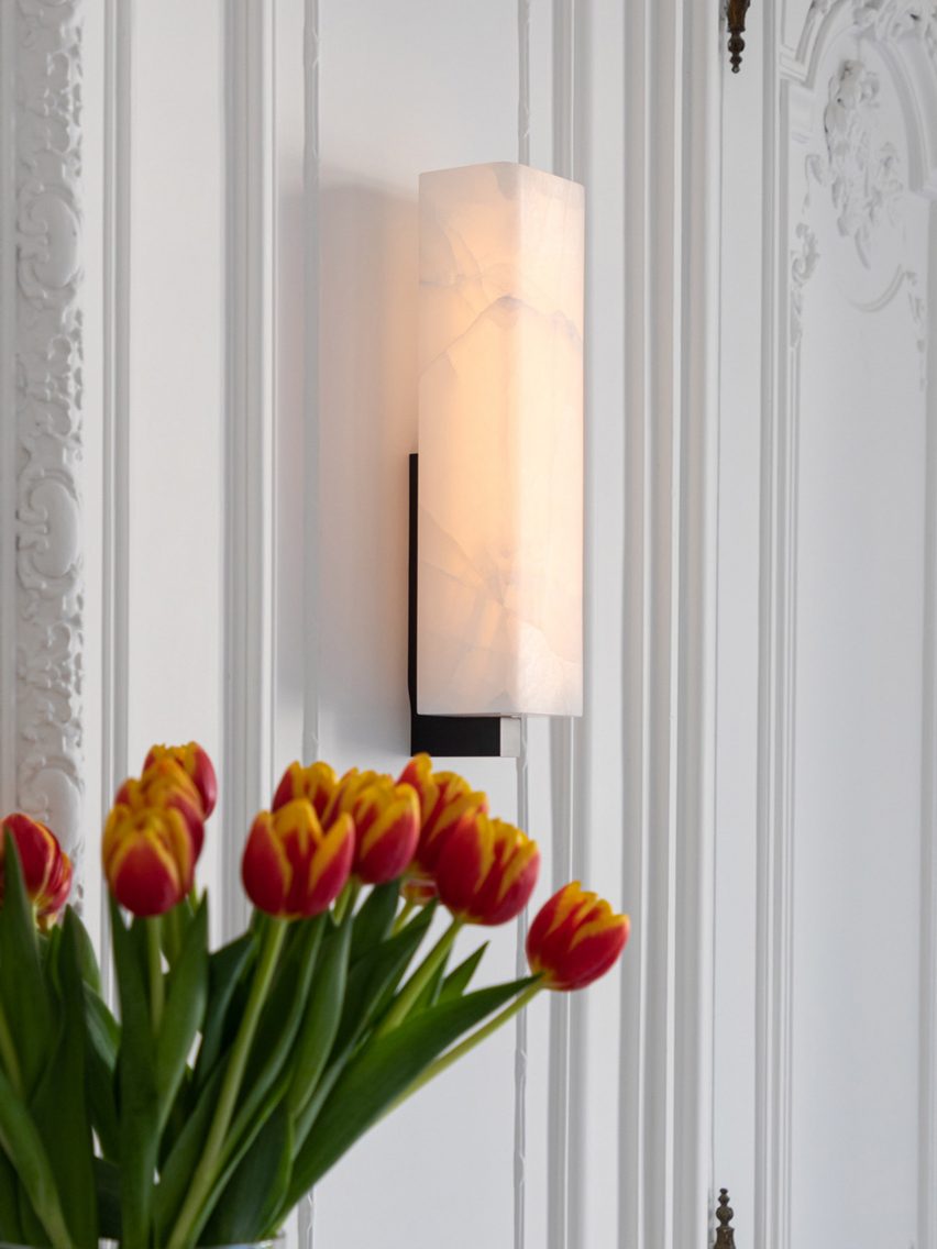 Embrun wall light on panelled white walls with red tulips