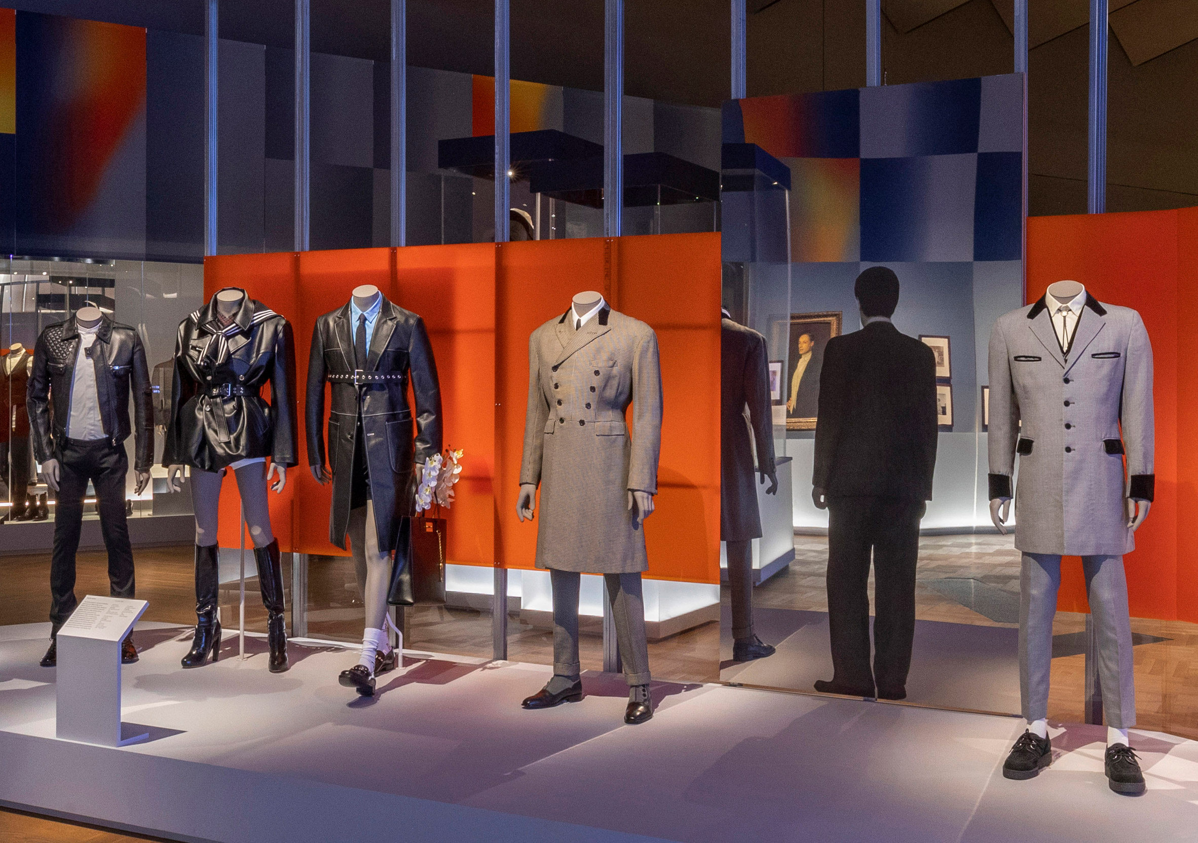 Standing Man is pictured among mannequins in tailoring 