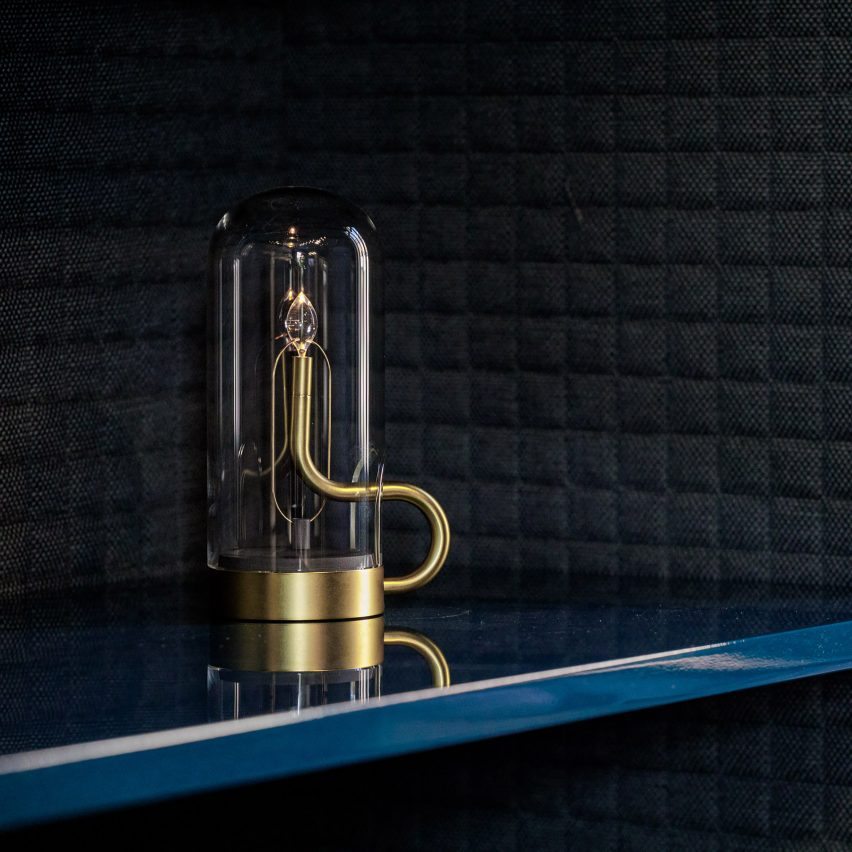 A photograph of the hymn lamp by Hiroto Yoshizoe for Ambientec on a blue shelf