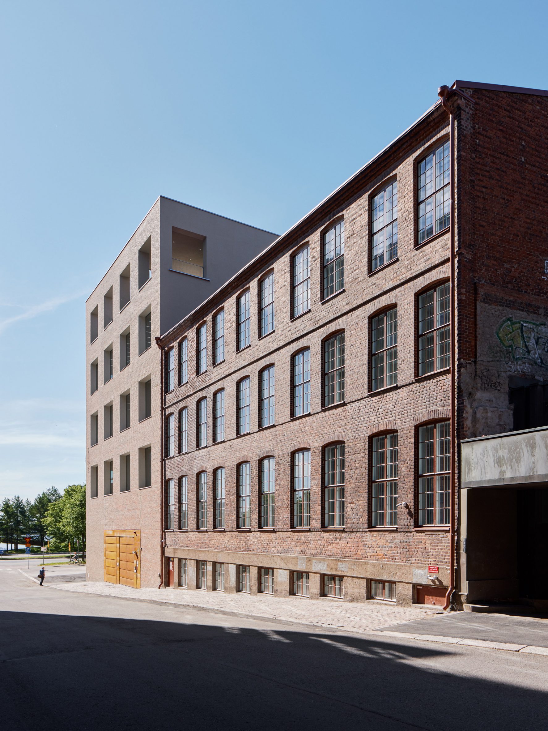 Exterior of the original warehouse building beside the new addition at the University of the Arts Helsinki