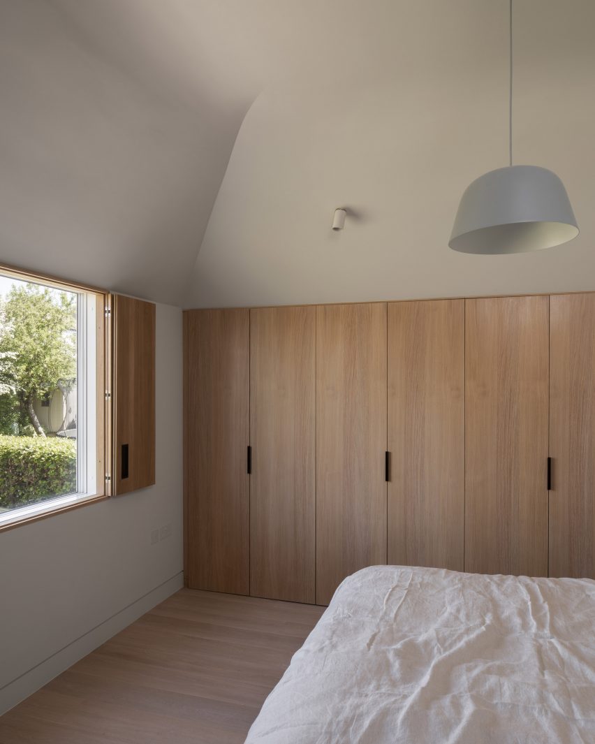 The bedroom has pale wood fixtures and fittings