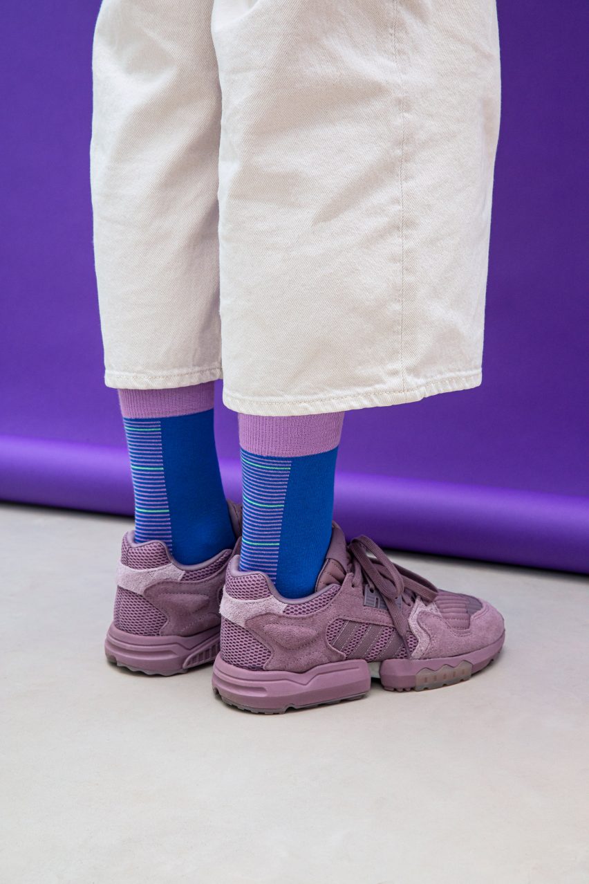 Temperature Textiles sea level socks in cool blue and purple colours with horizontal lines up the back of the leg communicating projected sea level rise