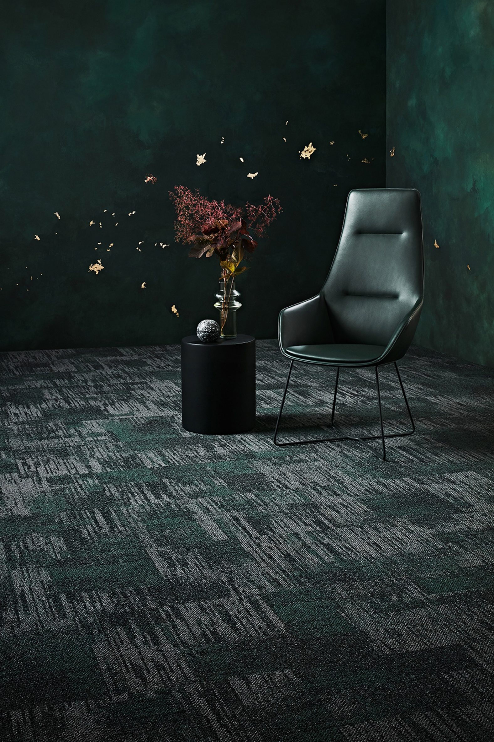 A photograph of Raw Elements carpet tiles in shades of green and grey