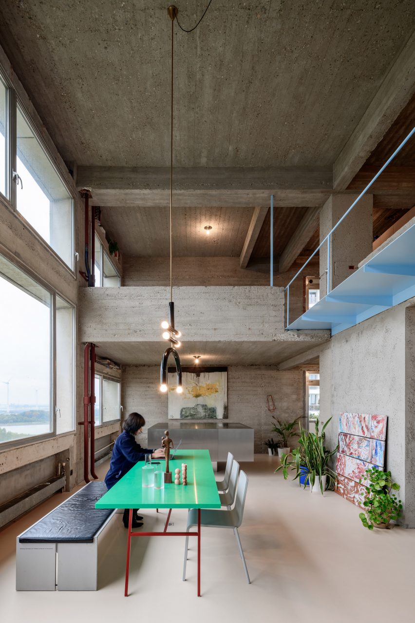Dining area of brutalist apartment in Antwerp by Studio Okami Architecten