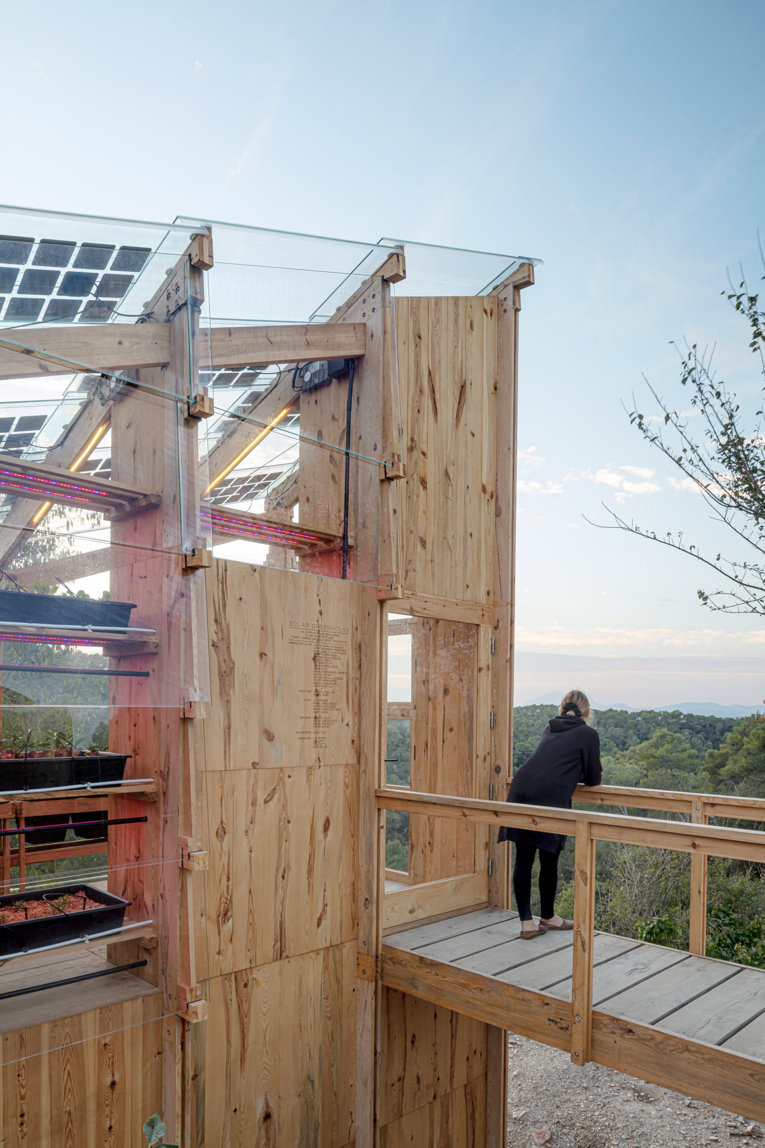 Person is pictured on the footbridge of Solar Greenhouse