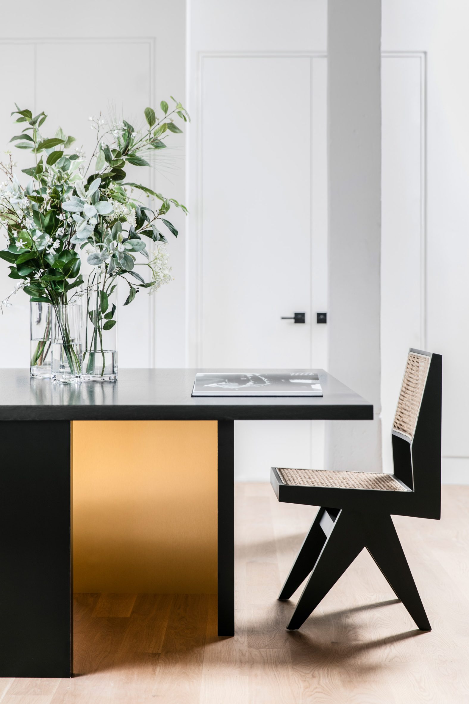 Black table with gold accent and a black chair