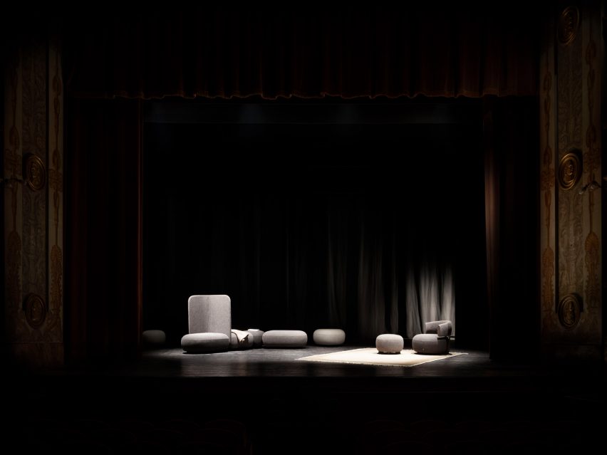 Code poufs on a theatre stage with spot lighting