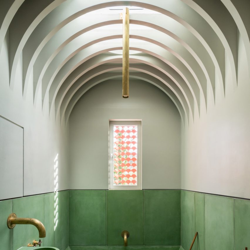 Vaulted ceiling in green bathroom