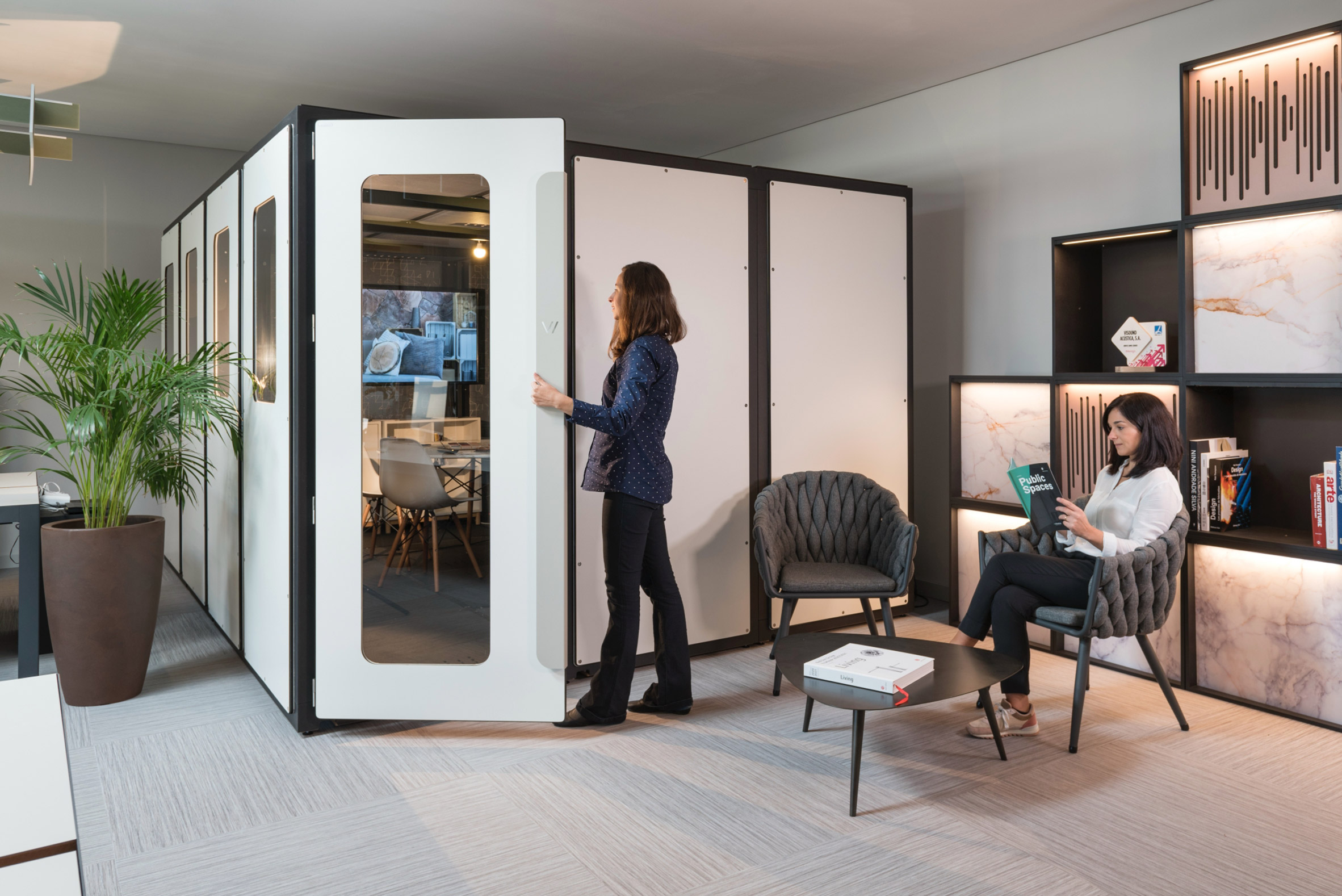 Vicbooth Office pod by Vicoustic used in the corner of an office with white walls and glass door