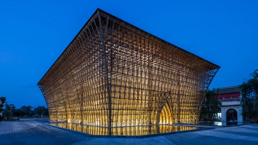 The bamboo building is illuminated from the inside