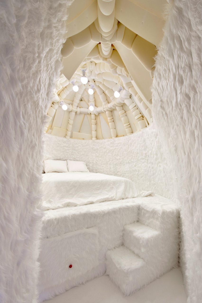 Interior of Winter Bedroom by Takk with foam-covered dome ceiling and bed on a raised platform covered by fluffy white carpet