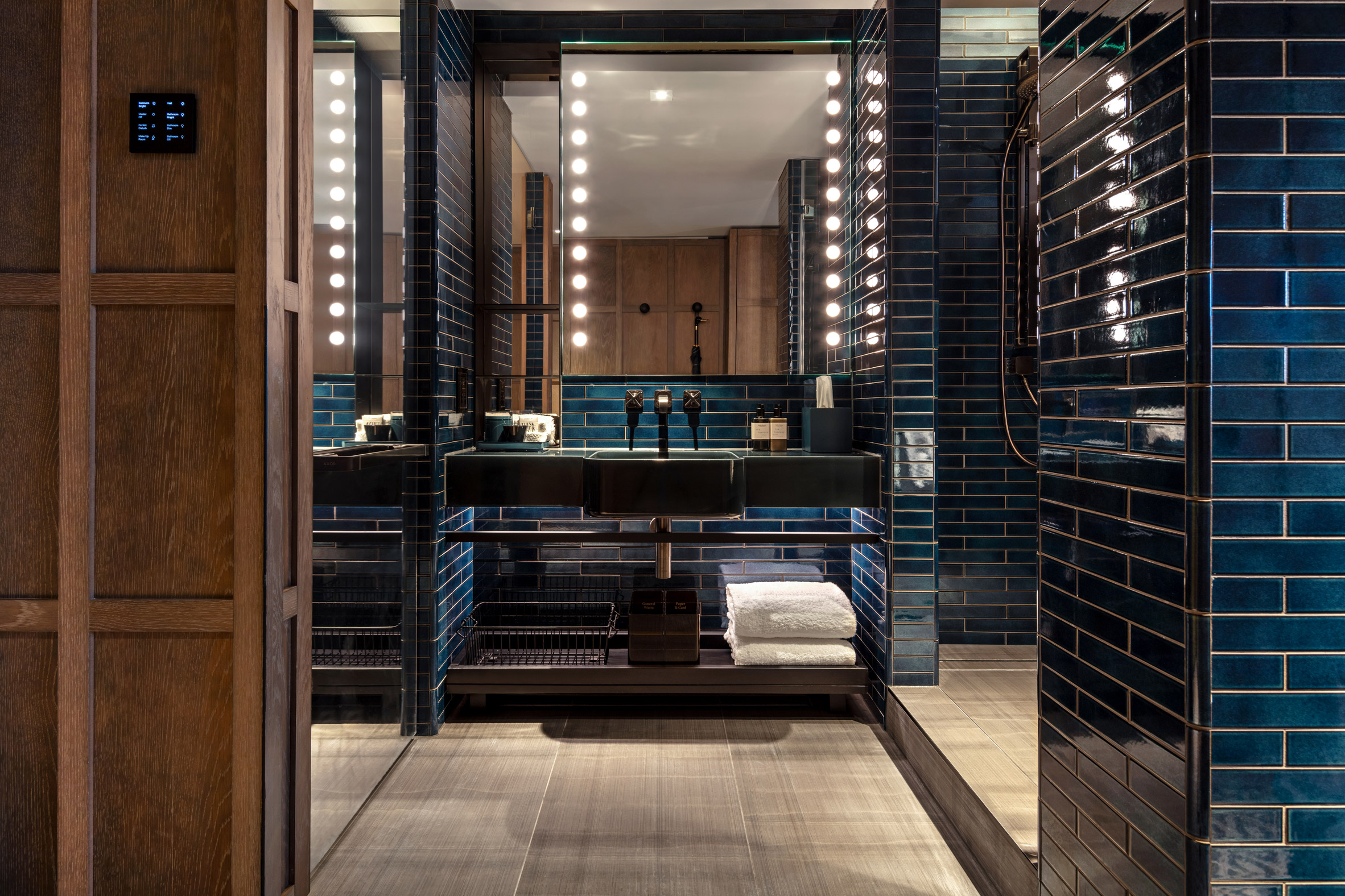 A photograph of The Londoner's bathroom featuring navy tiles